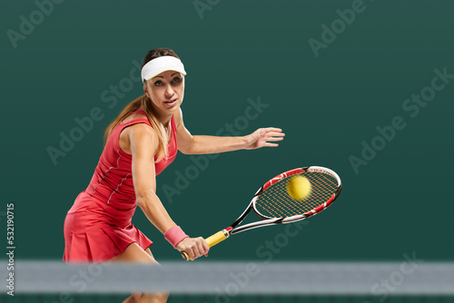 Portrait of young fit happy sportswoman having tennis match on court