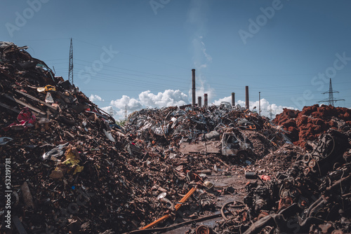 junkyard with factory in background photo