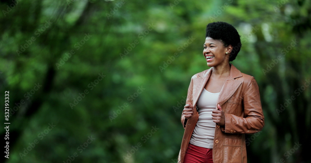 Woman laughing outside. Happy African person real life laugh and smile