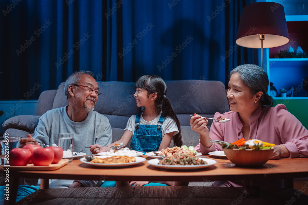 Asian happy family having lunch on dinner japanese table smiling together. little kid daughter enjoy eating food grandparents. Happiness time people lifestyle concept. Asian happy family having lunch on dinner japanese table smiling together. little kid daughter enjoy eating food grandparents. Happiness time people lifestyle concept.