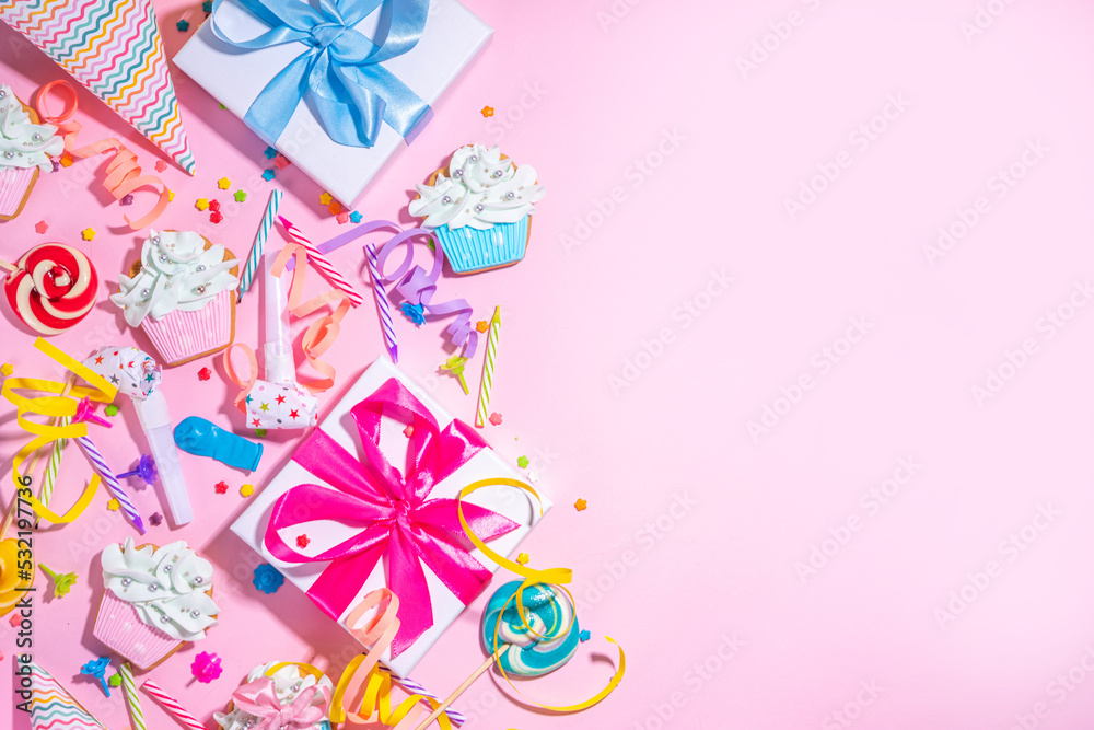 Happy birthday greeting card background. Flatlay with colorful holiday tools - birthday party caps, blowers, gift boxes , balloons, steamers, candles, on pink background copy space Happy birthday greeting card background. Flatlay with colorful holiday tools - birthday party caps, blowers, gift boxes , balloons, steamers, candles, on pink background copy space