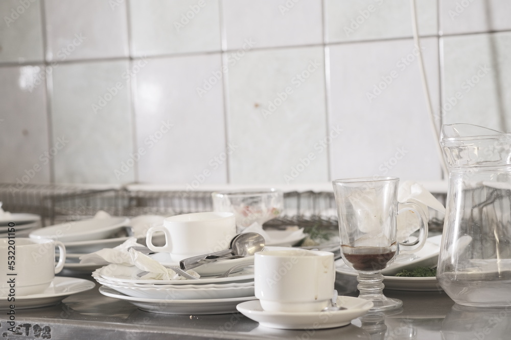 Dirty dishware on metal table Dirty dishware on metal table