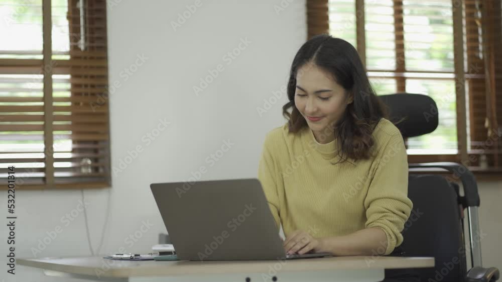 Attractive Asian woman with long hair, black, working, using hands, laptop device work online from home in the living room with cheerfulness, freshness, expressiveness, comfortable lifestyle Attractive Asian woman with long hair, black, working, using hands, laptop device work online from home in the living room with cheerfulness, freshness, expressiveness, comfortable lifestyle