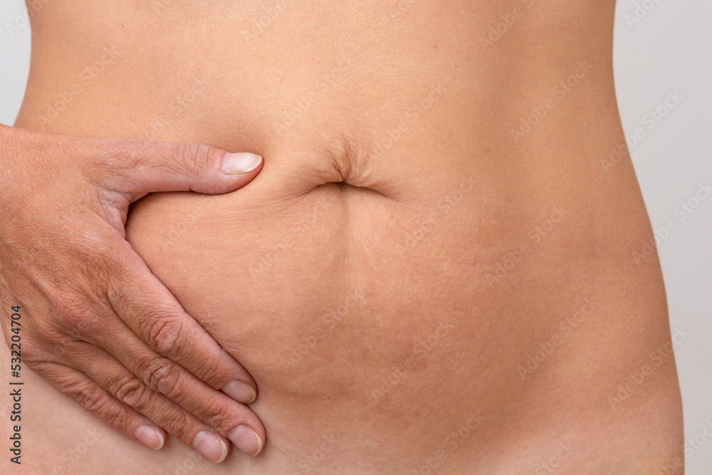 Cropped woman hand on right side of stomach to show pain or symptom there