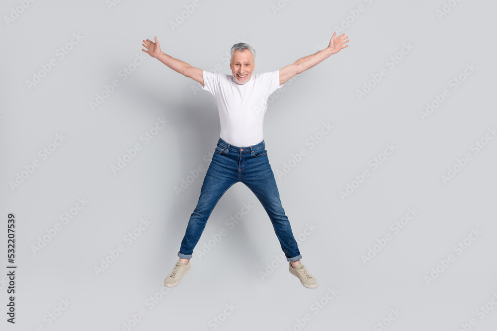 Full length body size view of attractive cheery crazy lucky man jumping having fun isolated over grey pastel color background