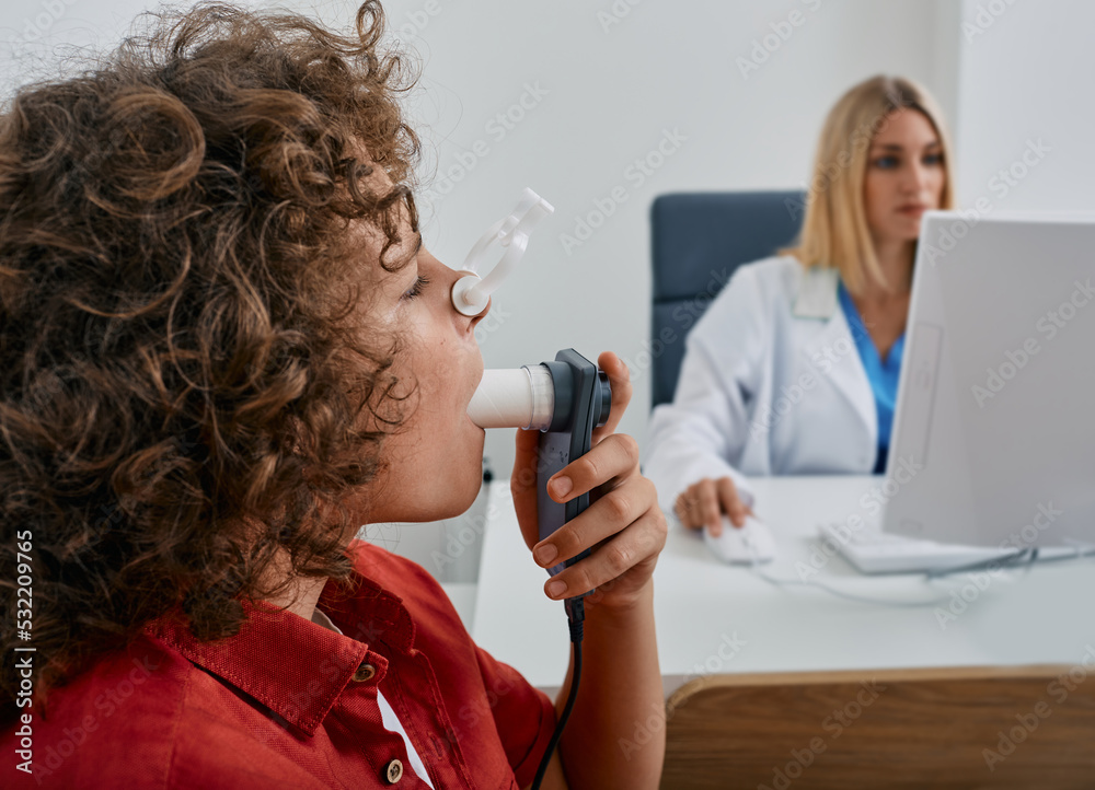 Male child during breathing spirometry and pulmonary function test