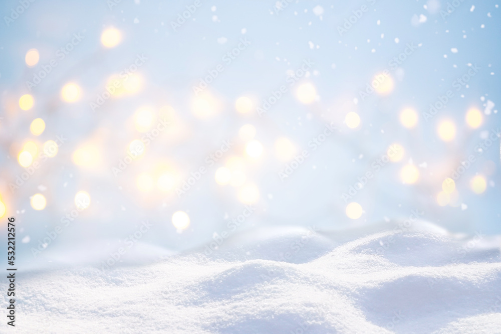Beautiful background image with small snowdrifts close-up and blurry holiday lights.