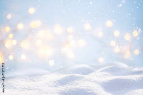Beautiful background image with small snowdrifts close-up and blurry holiday lights. © Laura Pashkevich