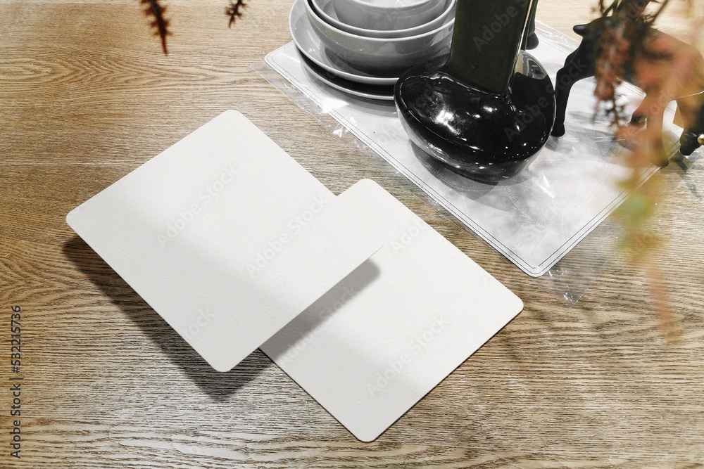Clean minimal square flyer mockup on wooden table with dry plant vase