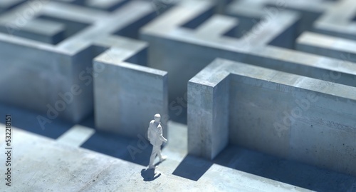 A confused businessman thinking the solution way while standing on a question mark platform above a detailed maze photo