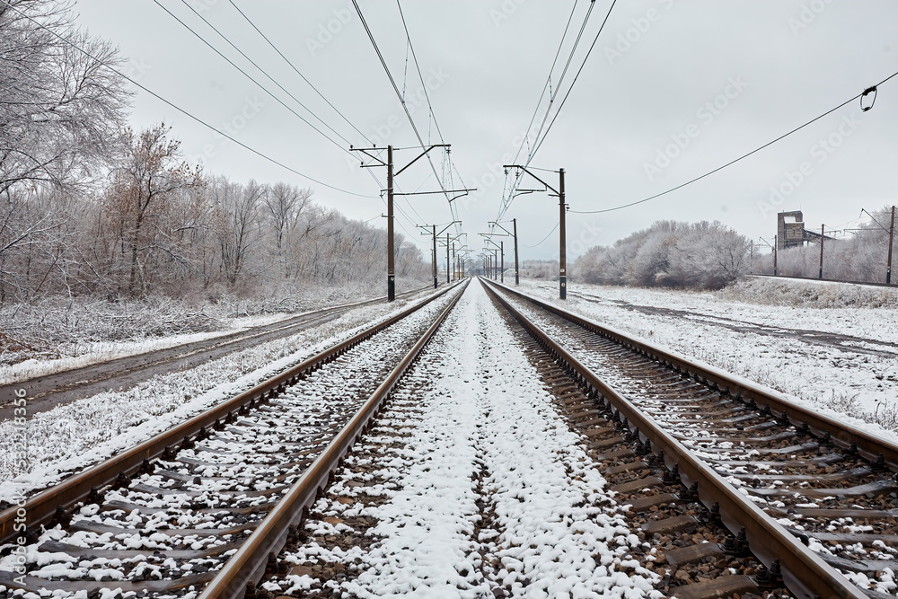 Train tracks in winter with frost covering around everywhere