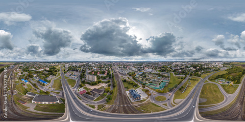 aerial full seamless spherical 360 hdri panorama view above road junction with traffic and the bridge over the railway in city overlooking of residential area in equirectangular projection.