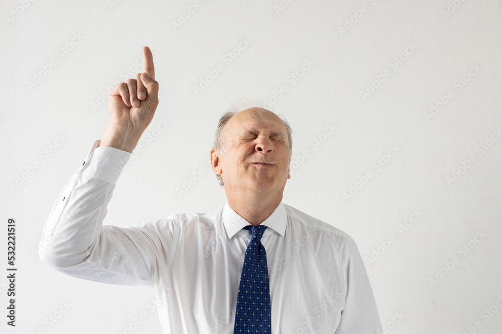Portrait of delightful mature businessman showing forefinger. against white background. Senior manager wearing formalwear making idea gesture and frowning. Solution and idea concept Portrait of delightful mature businessman showing forefinger. against white background. Senior manager wearing formalwear making idea gesture and frowning. Solution and idea concept