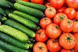 Cucumbers and tomatoes on the counter in the store. Trade in vegetables wholesale and retail. Close-up
