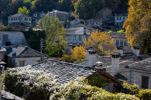 Autumnal landscape showing the stone houses of traditional architecture in the village of Dilofo in Epirus, Greece photo