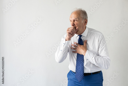 Photos Portrait of mature businessman suffering from severe cough