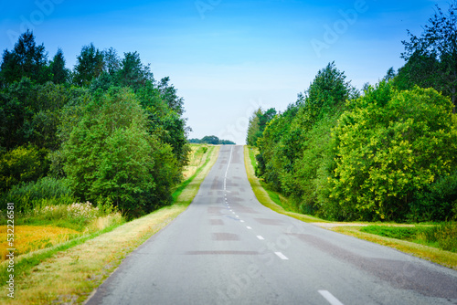 A country empty road along with nature,holiday and travel concept.Summer day.
