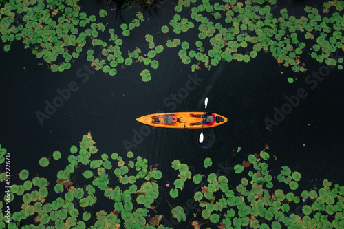 aerial top view of man paddling kayaking in the lotus lake at rayong botanical garden in thailand For tourist services. © SHUTTER DIN