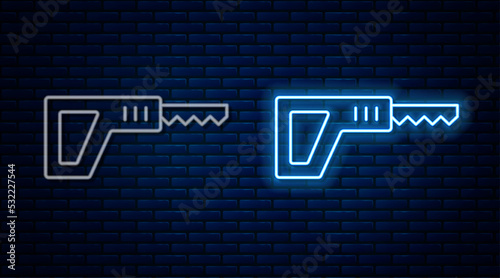 Glowing neon line Reciprocating saw and saw blade icon isolated on brick wall background. Vector