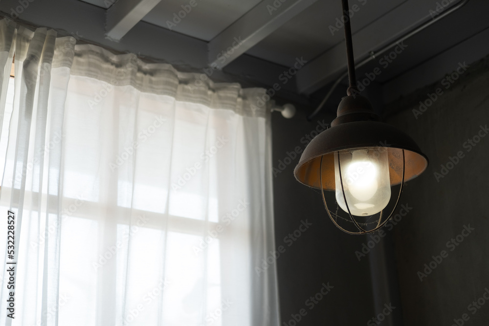 Vintage lamp near window with white curtain. Close up