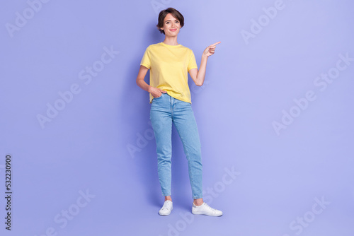 Full size photo of young adorable gorgeous nice pretty woman wear stylish outfit pointing empty space new shopping mall brand isolated on purple color background © deagreez