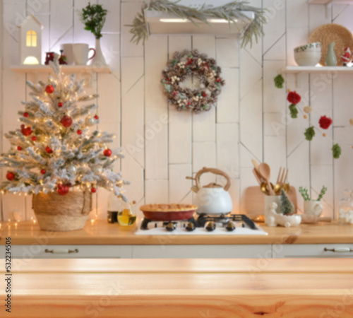 Empty wooden table on background of light christmas kitchen in scandinavian style. Christmas background. Ready for product montage.Merry Christmas and Happy New Year! Banner.Mockup.
