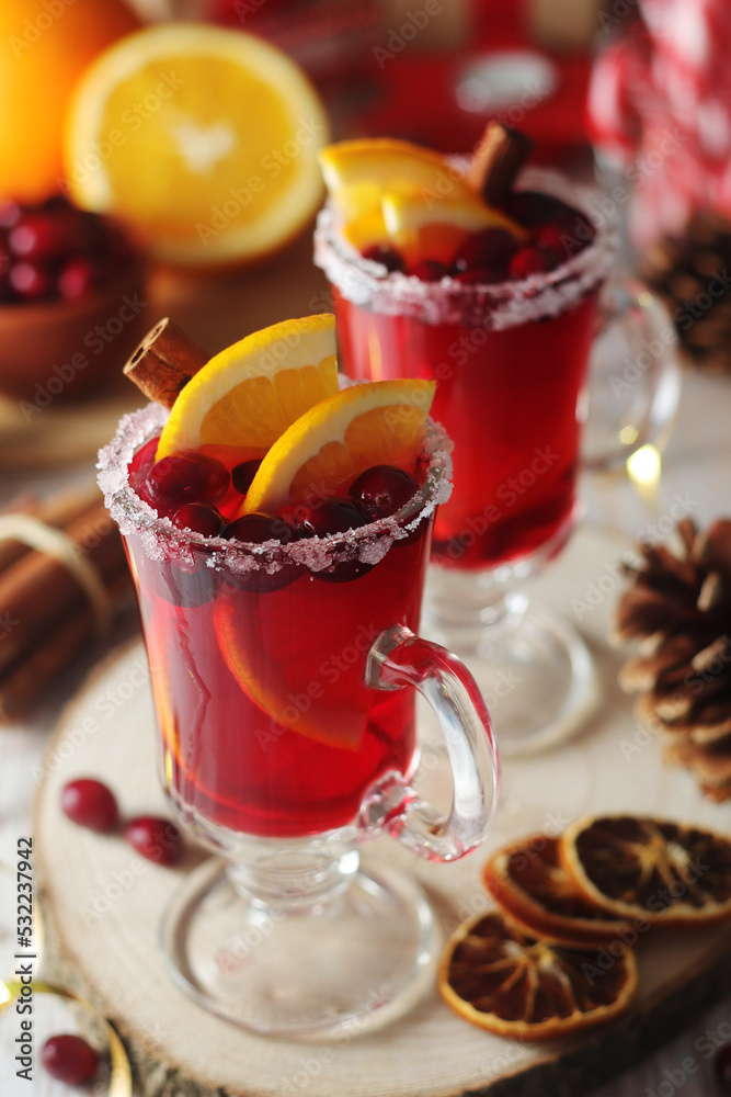 Glasses with warm cranberry with oranges drinks Glasses with warm cranberry with oranges drinks