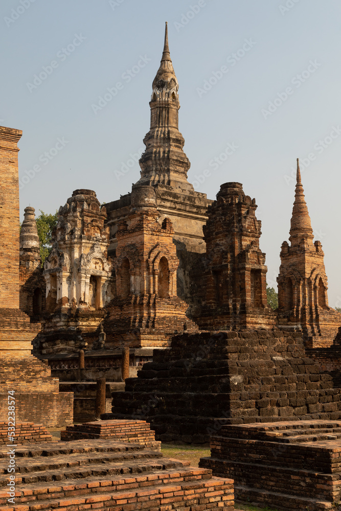Wat Mahathat temple and several pagodas in Sukhothai Historical Park at sunset, Thailand