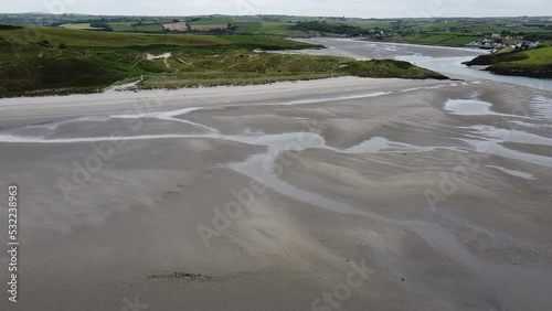 Huge sandy beach of Inchydoney at low tide, aerial view. Coastal sand dunes covered with marram grass. Seaside landscape of southern Ireland. Clonakilty Bay. photo