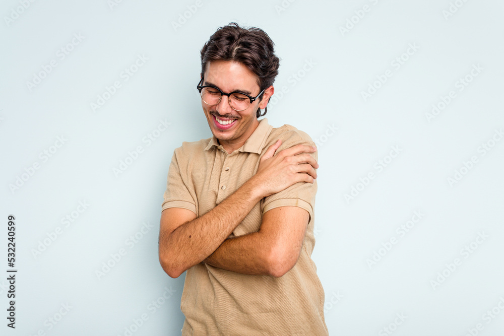 Young hispanic man isolated on blue background laughing and having fun. Young hispanic man isolated on blue background laughing and having fun.