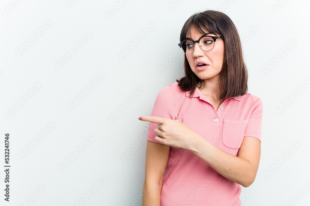 Young caucasian woman isolated on white background smiling and pointing aside, showing something at blank space. Young caucasian woman isolated on white background smiling and pointing aside, showing something at blank space.