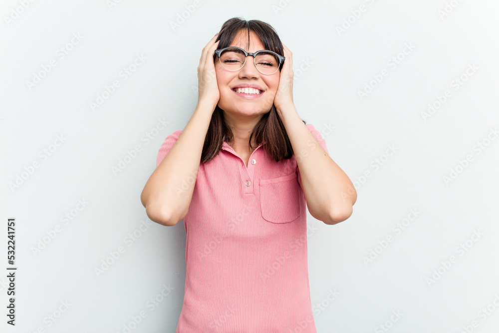 Young caucasian woman isolated on white background laughs joyfully keeping hands on head. Happiness concept. Young caucasian woman isolated on white background laughs joyfully keeping hands on head. Happiness concept.