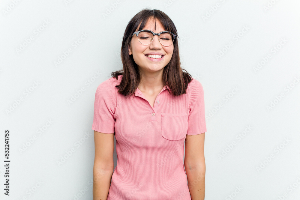 Young caucasian woman isolated on white background laughs and closes eyes, feels relaxed and happy. Young caucasian woman isolated on white background laughs and closes eyes, feels relaxed and happy.