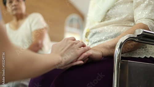 Close up shot of people hands are having encouragement to elderly.