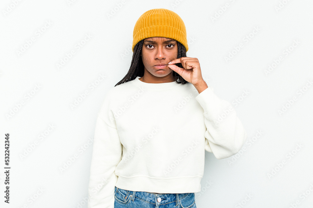 Young African American woman isolated on white background with fingers on lips keeping a secret.