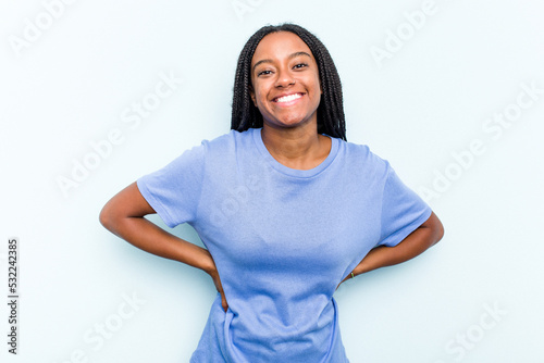 Young African American woman with braids hair isolated on blue background happy, smiling and cheerful. © Asier