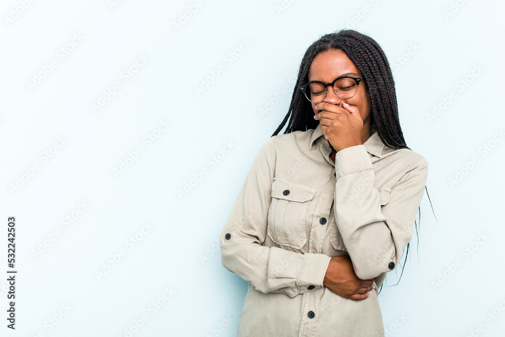 Young African American woman with braids hair isolated on blue background laughing happy, carefree, natural emotion. Young African American woman with braids hair isolated on blue background laughing happy, carefree, natural emotion.