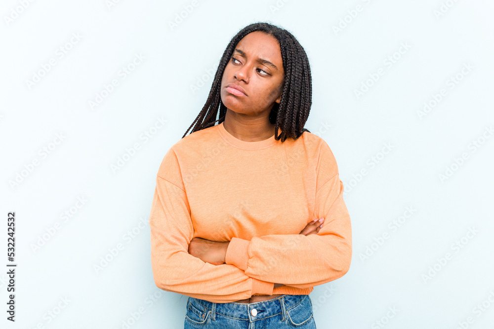 Young African American woman with braids hair isolated on blue background dreaming of achieving goals and purposes Young African American woman with braids hair isolated on blue background dreaming of achieving goals and purposes