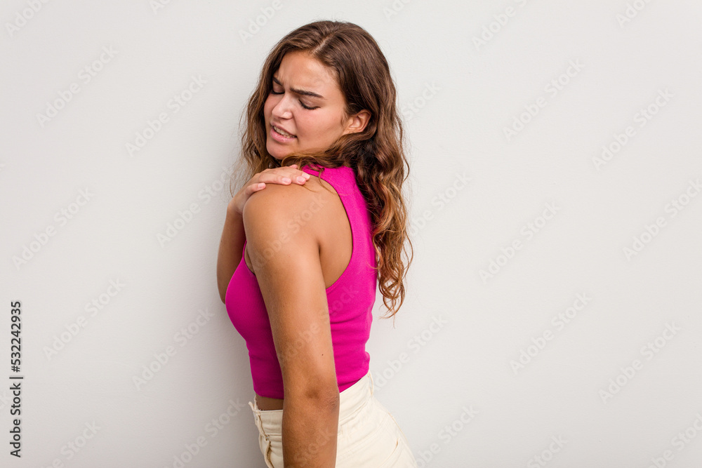 Young caucasian woman isolated on blue background having a shoulder pain. Young caucasian woman isolated on blue background having a shoulder pain.
