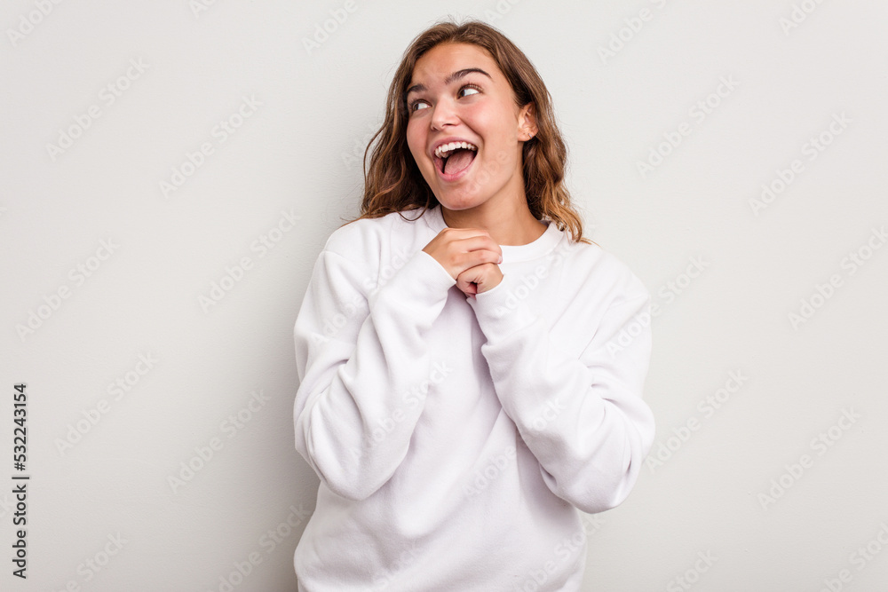Young caucasian woman isolated on blue background praying for luck, amazed and opening mouth looking to front. Young caucasian woman isolated on blue background praying for luck, amazed and opening mouth looking to front.
