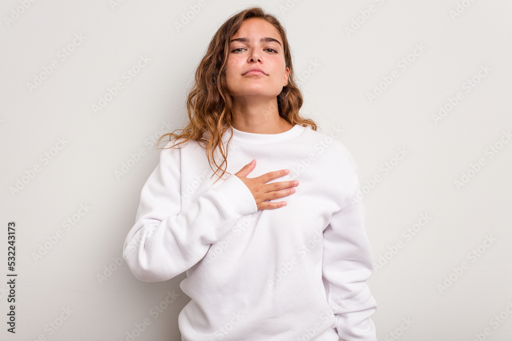 Young caucasian woman isolated on blue background taking an oath, putting hand on chest. Young caucasian woman isolated on blue background taking an oath, putting hand on chest.