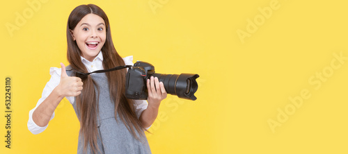 happy teen girl photographer use digital photo camera show thumb up, photographing. Child photographer with camera, horizontal poster, banner with copy space.