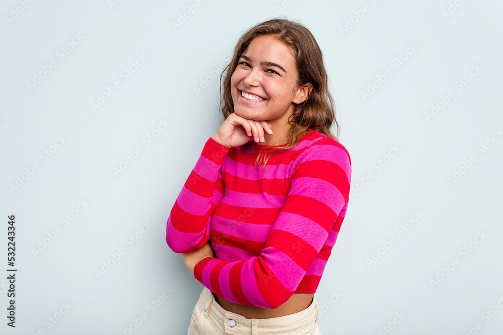 Young caucasian woman isolated on blue background smiling happy and confident, touching chin with hand. Young caucasian woman isolated on blue background smiling happy and confident, touching chin with hand.