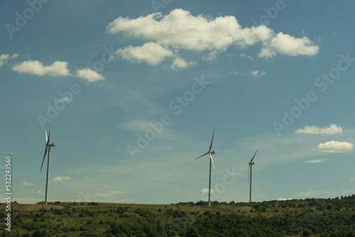Power of wind turbine generating electricity clean energy with cloud background on the sky. Global ecology.