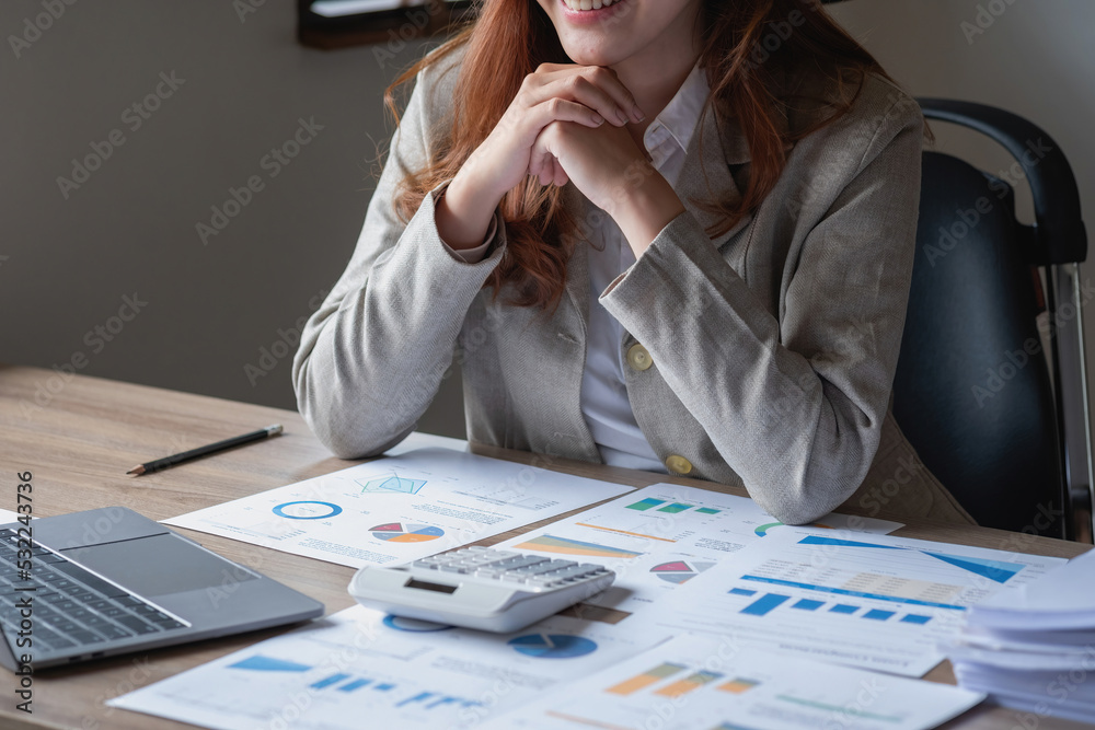 Marketing, Financial, Accounting, Planning, business women analyze company results and profits with graph statistics. Use a laptop computer and a calculator to calculate the company's balance. Marketing, Financial, Accounting, Planning, business women analyze company results and profits with graph statistics. Use a laptop computer and a calculator to calculate the company's balance.