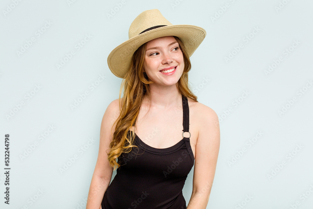 Young caucasian woman going to the beach isolated on blue background dreaming of achieving goals and purposes Young caucasian woman going to the beach isolated on blue background dreaming of achieving goals and purposes