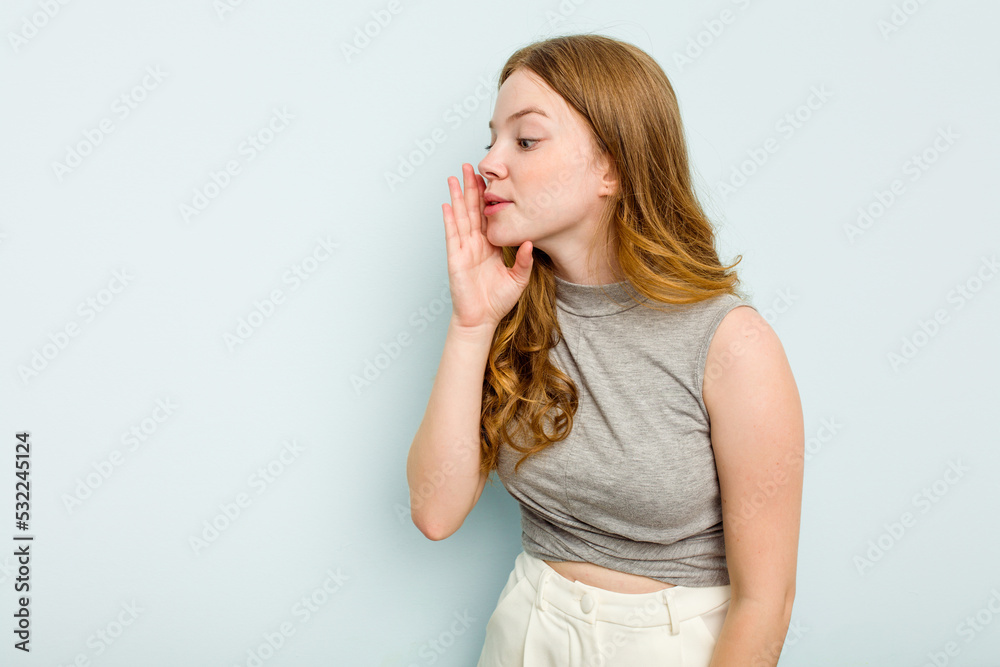 Young caucasian woman isolated on blue background is saying a secret hot braking news and looking aside Young caucasian woman isolated on blue background is saying a secret hot braking news and looking aside