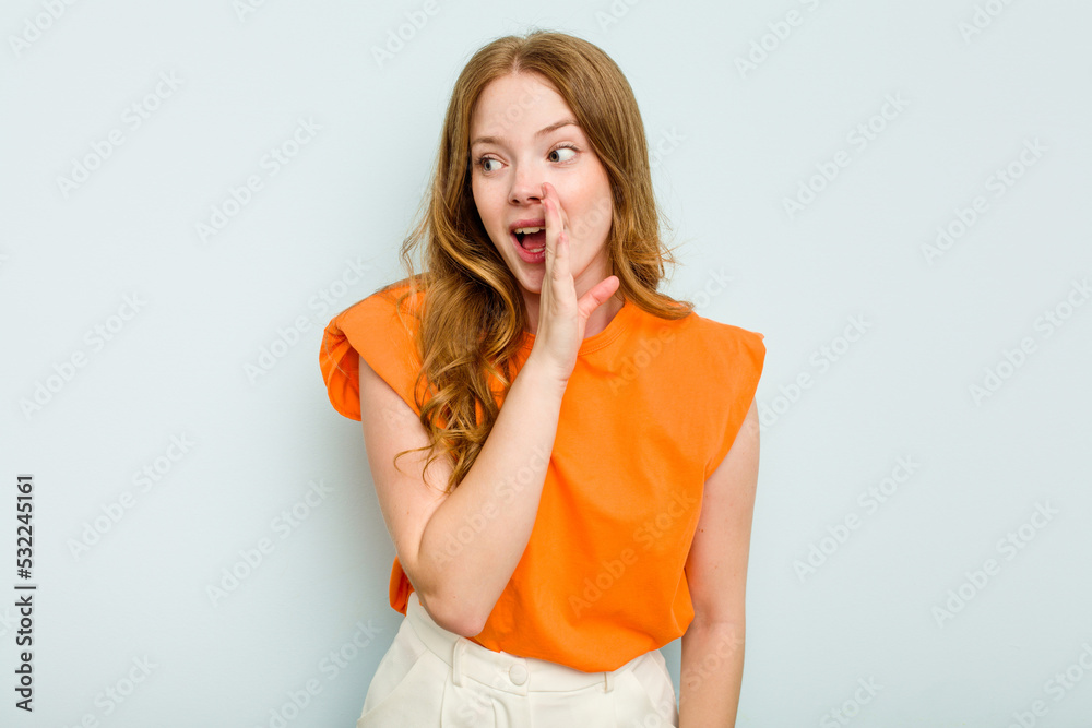 Young caucasian woman isolated on blue background shouting excited to front. Young caucasian woman isolated on blue background shouting excited to front.