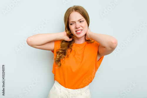 Young caucasian woman isolated on blue background suffering neck pain due to sedentary lifestyle.