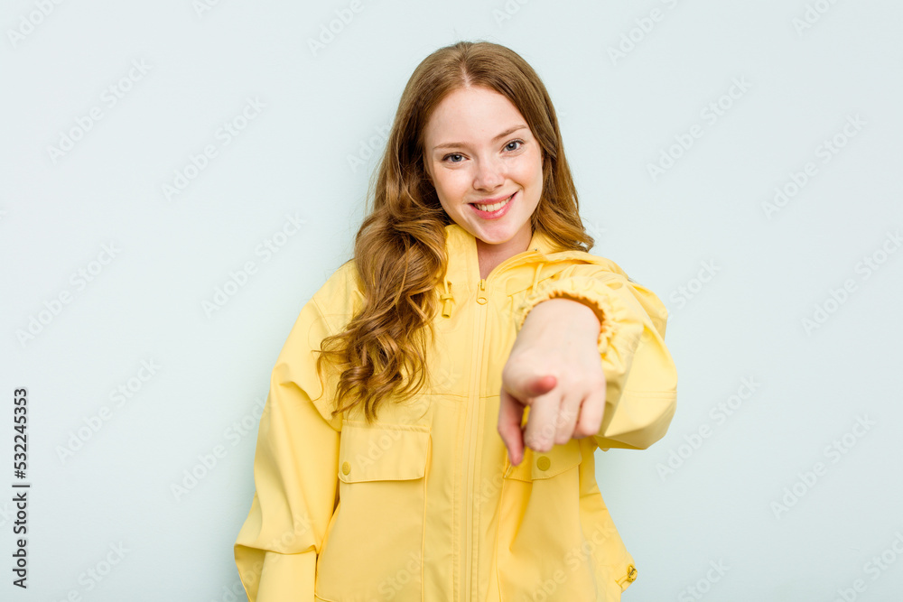 Young caucasian woman isolated on blue background cheerful smiles pointing to front. Young caucasian woman isolated on blue background cheerful smiles pointing to front.